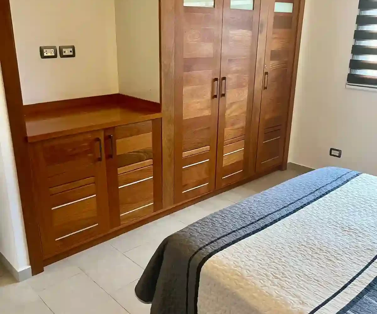 Habitación del apartamento en Aligio Las Terrenas con cama, decoración moderna y luz natural