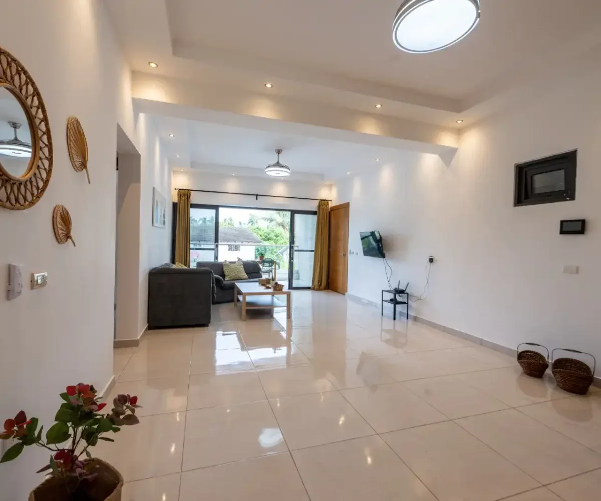 Amplia sala en Las Terrenas con vista al balcón y decoración moderna.